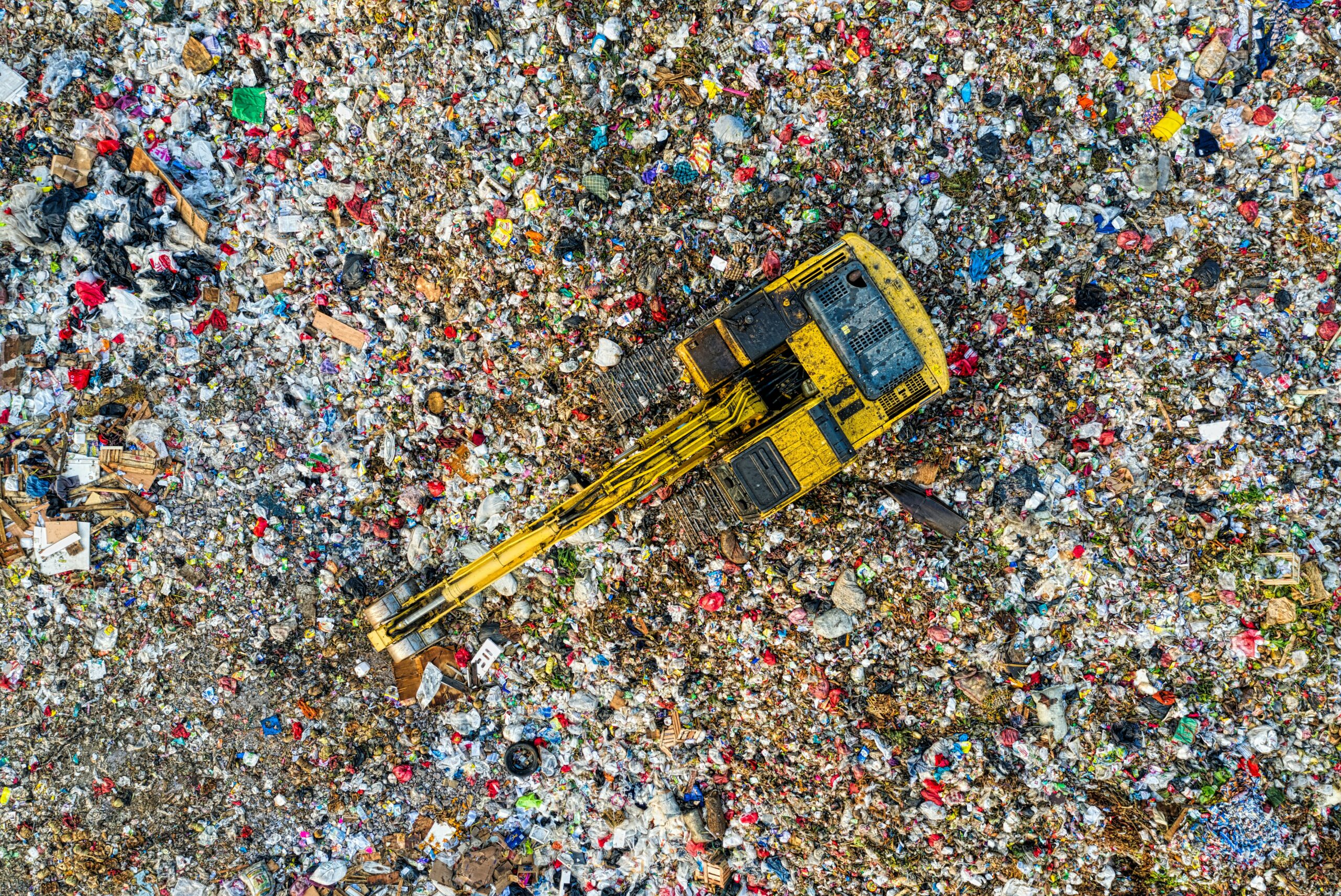 Excavator on a trash dump